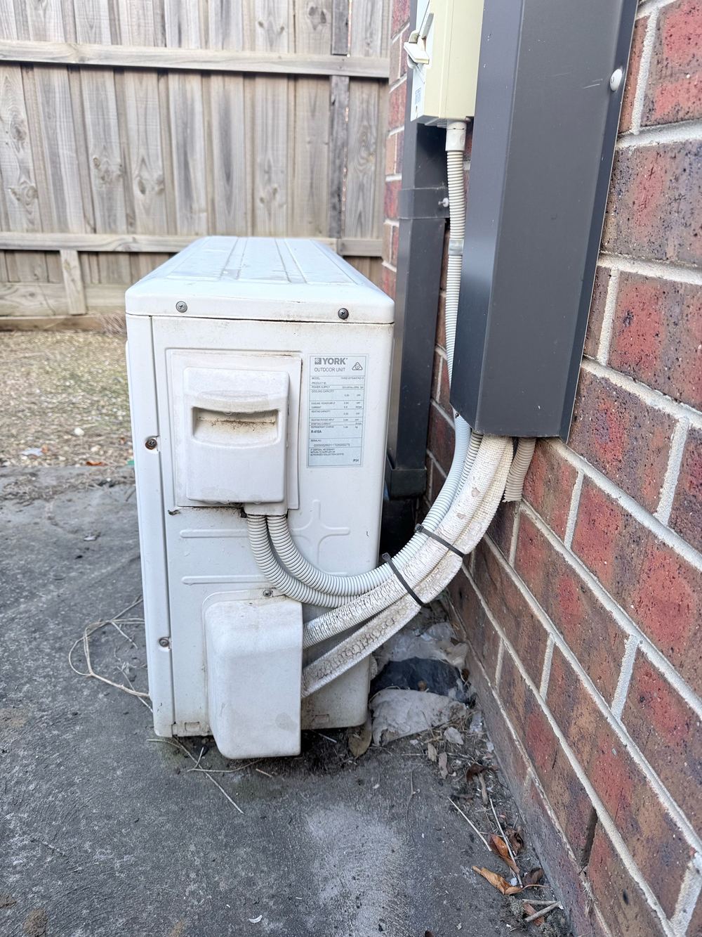 Air conditioner condensate and wet ground beside a Truganina slab
