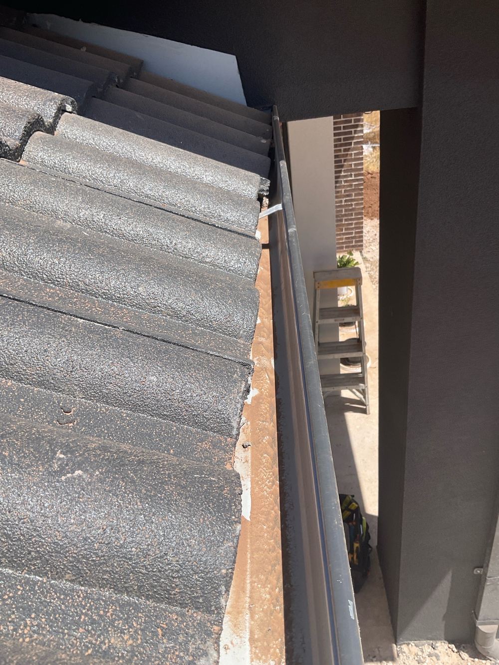 Roof tiles overhanging the gutter by more than the 65mm allowed, Truganina