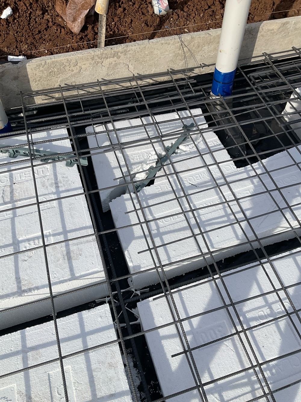 Reinforcement sitting without bar chairs, so it would end up too low in the concrete, found during a slab pre-pour inspection in Truganina